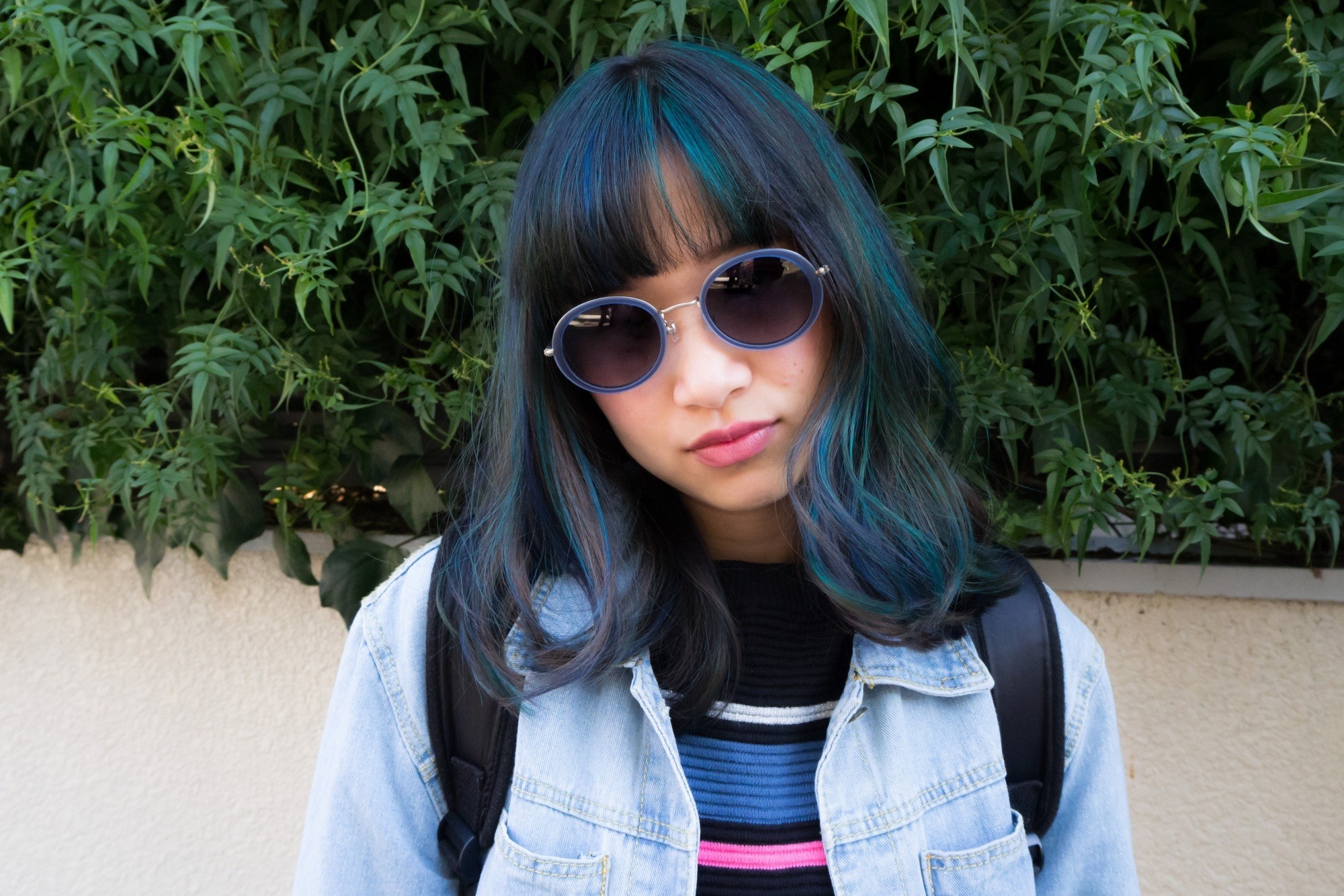 Asian woman with blue and teal highlights on black hair