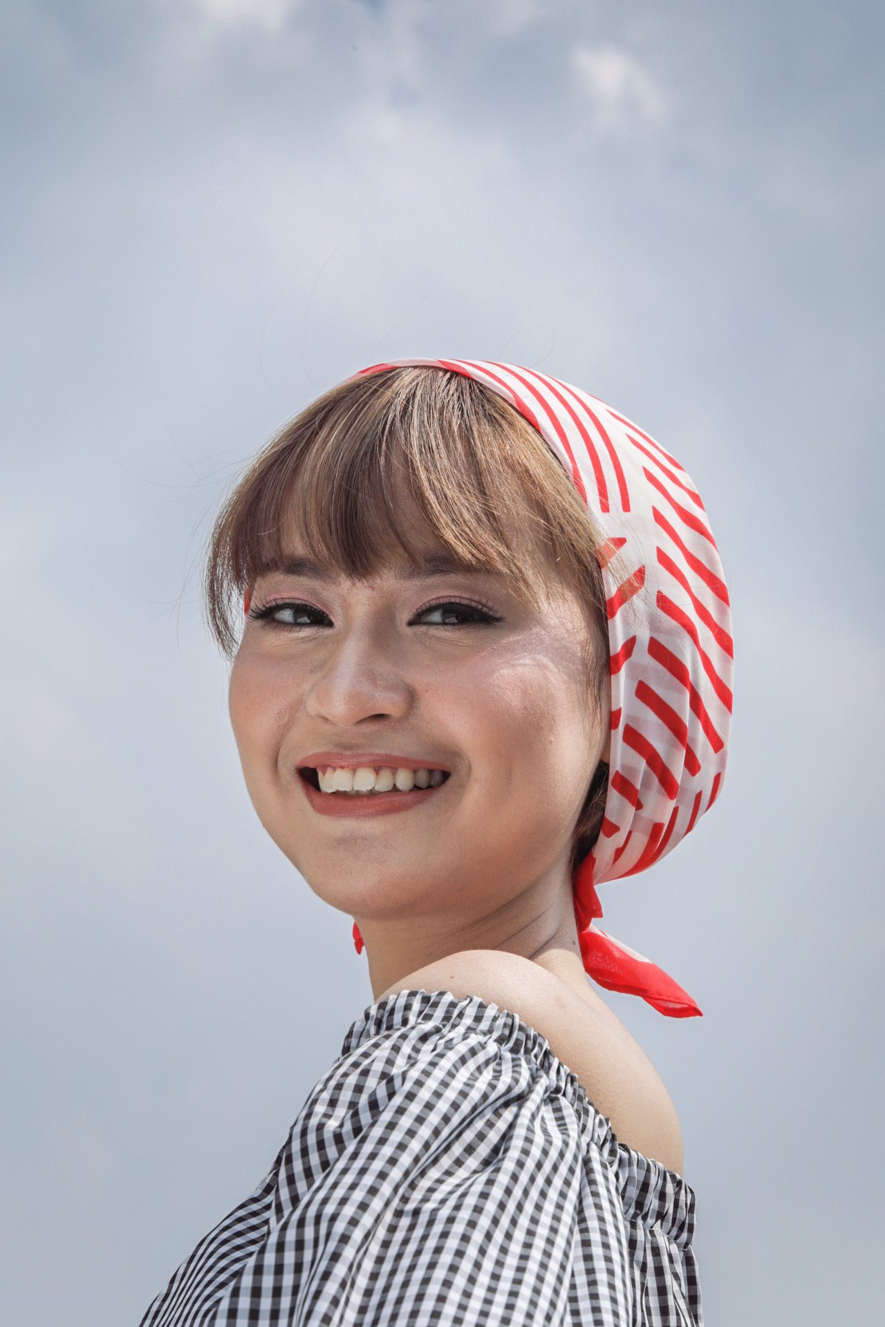 Asian woman wearing a bandana to protect her brittle hair