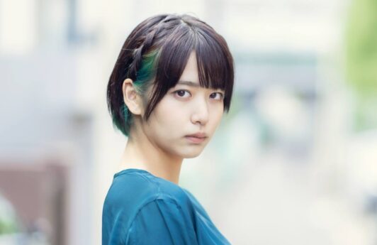Asian woman with braided short hair with bangs