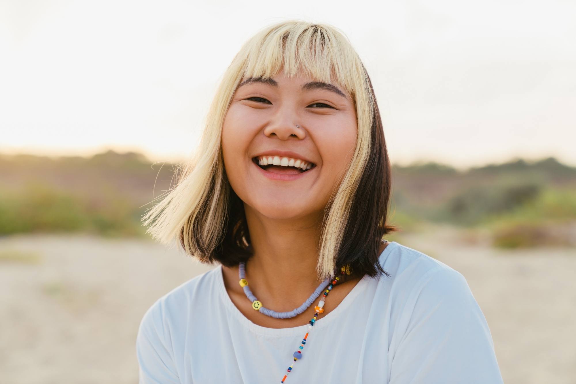 Asian woman with short hair with two-tone hair color