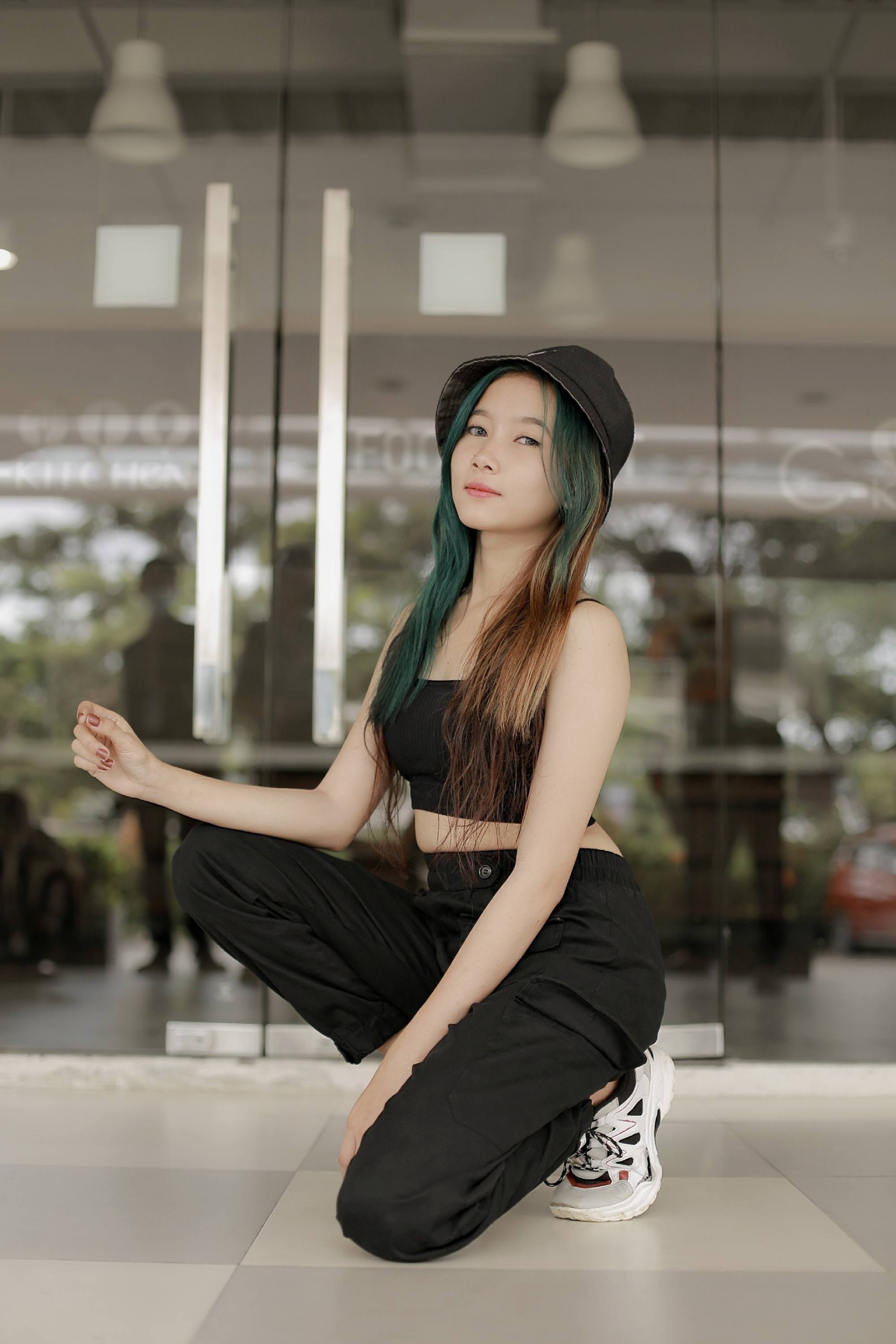 Asian woman with green and brown long hair