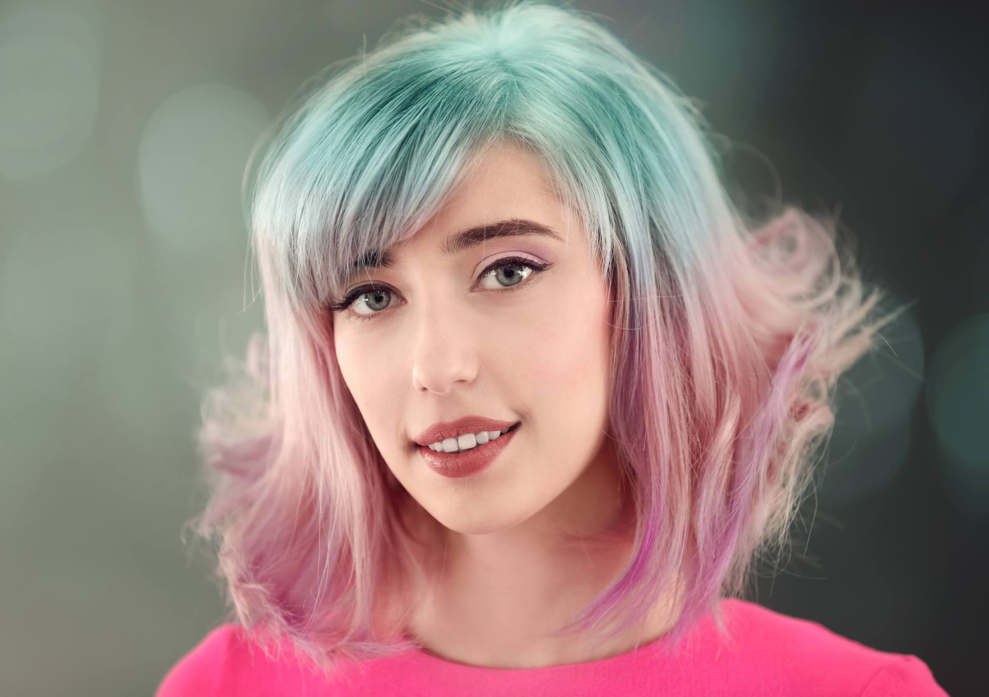 Woman with pastel pink and green two-tone hair