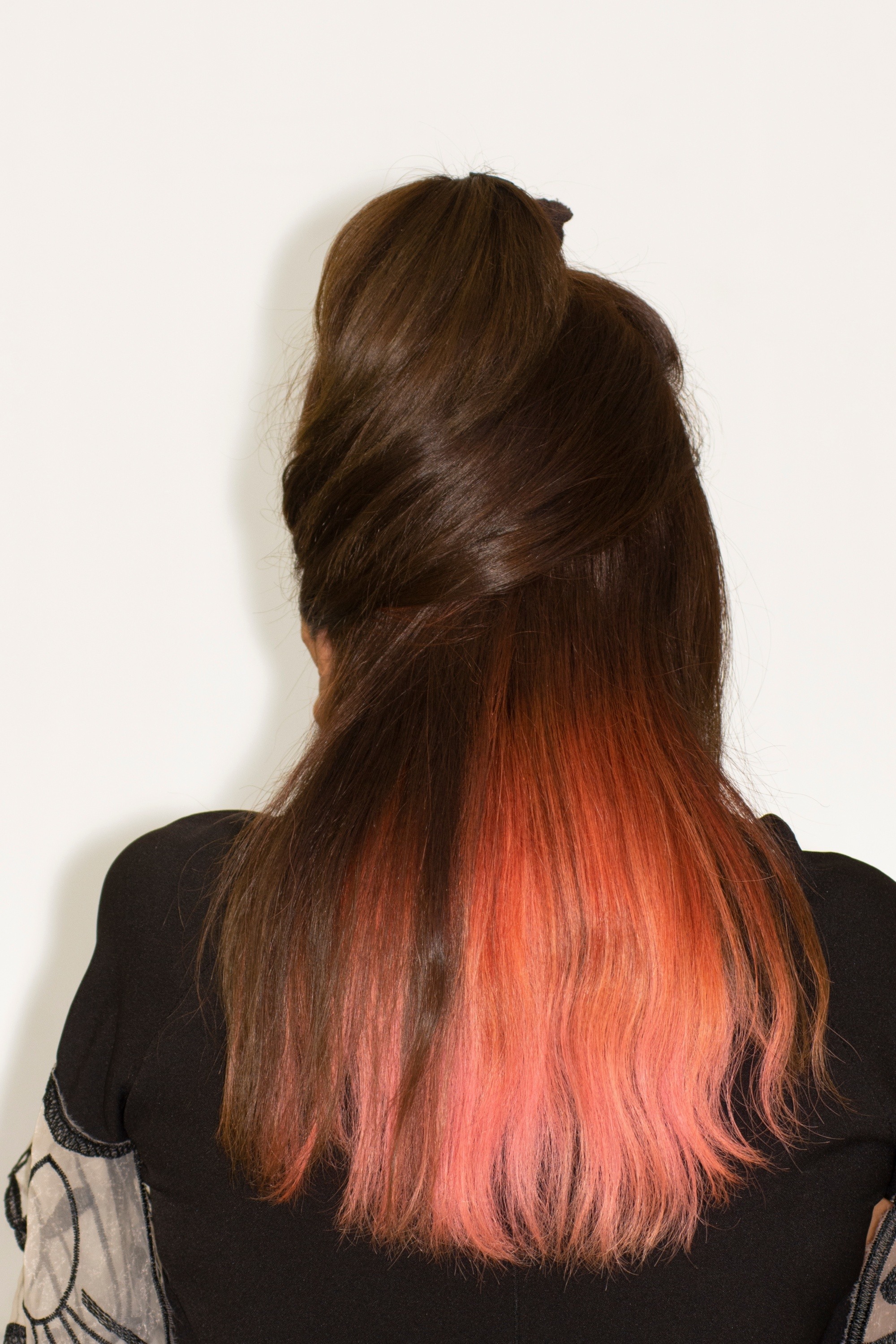 Back of a woman with a two-tone, black-and-orange hair color