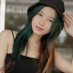 Asian woman with a brown-and-green two-tone hair color