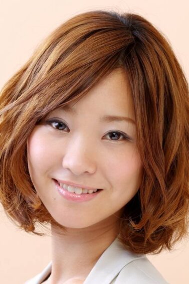 Asian woman with golden brown hair color on her textured bob hairstyle