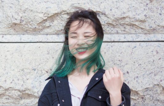 Asian woman with green hair color