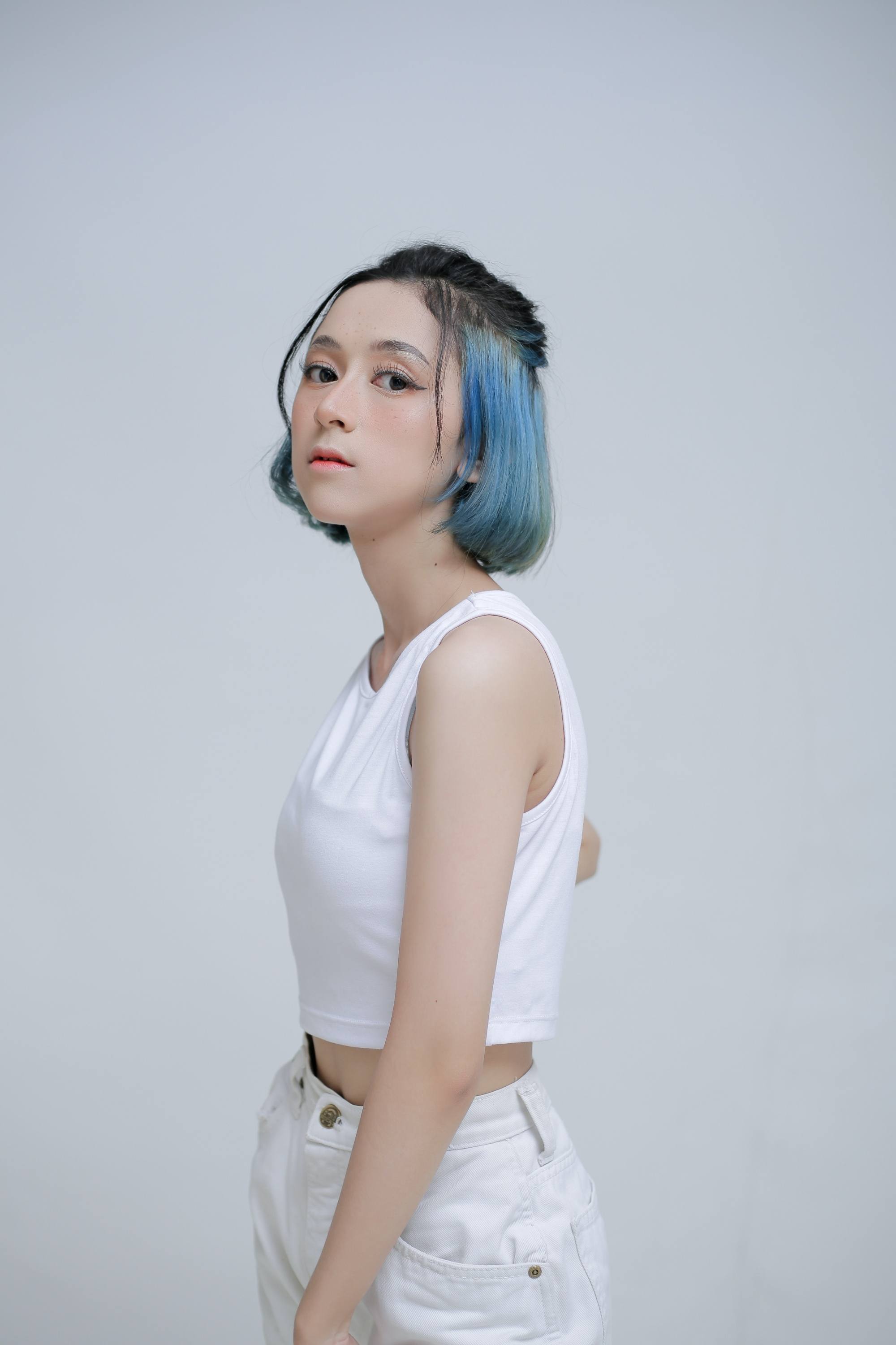 Asian woman with a cute hairstyle for short hair wearing a white tank top