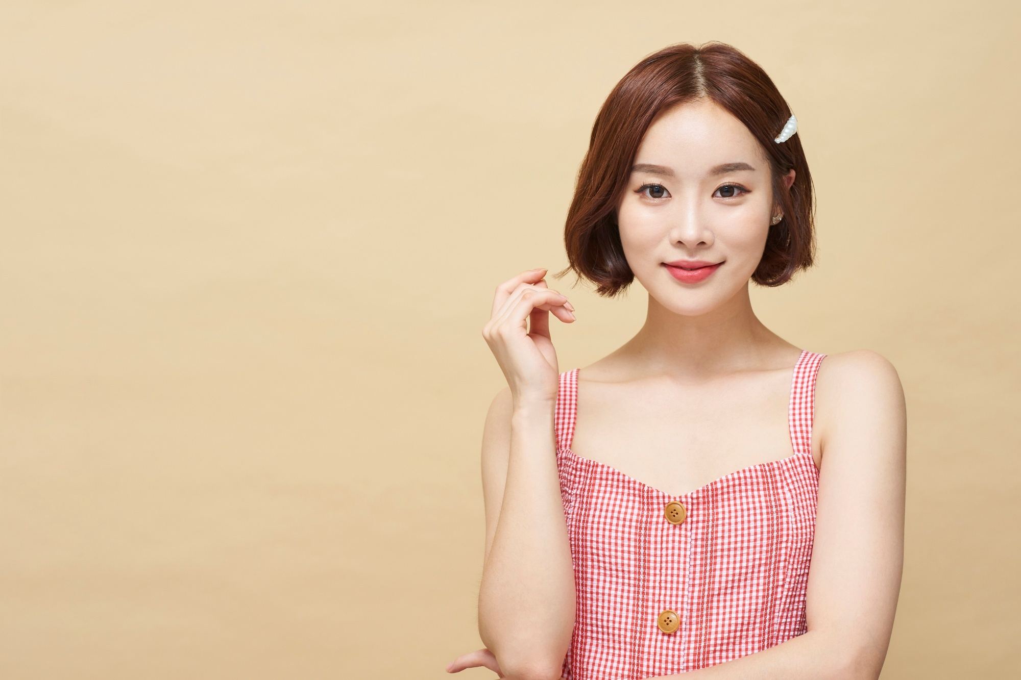 Asian woman with a white pearl hair clip on her short hair