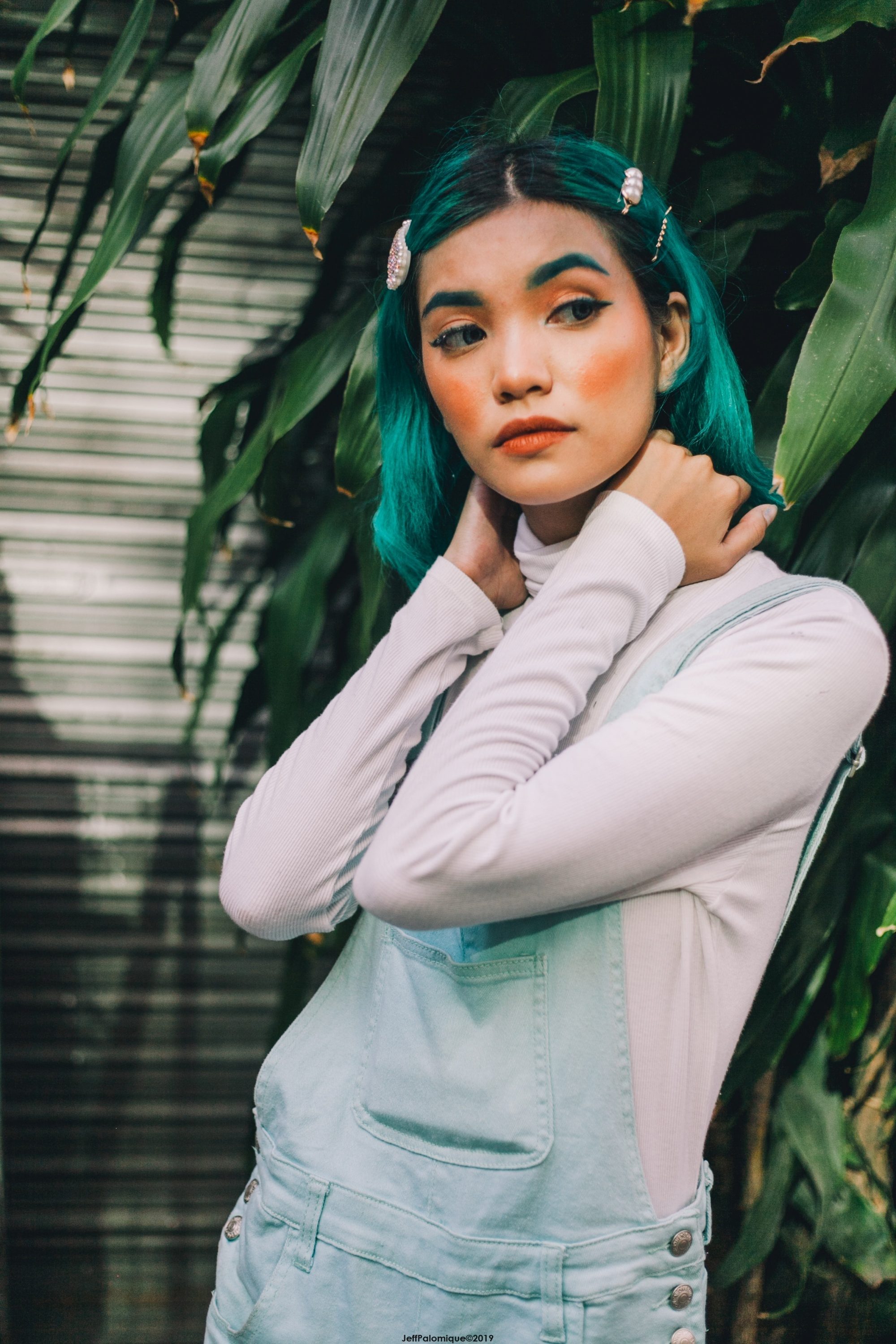 Asian woman with green hair and a cute hairstyle for short hair