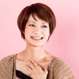 Asian woman with apple cut hair smiling