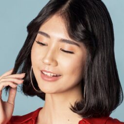 Asian woman with Korean short hair touching the tips of her hair