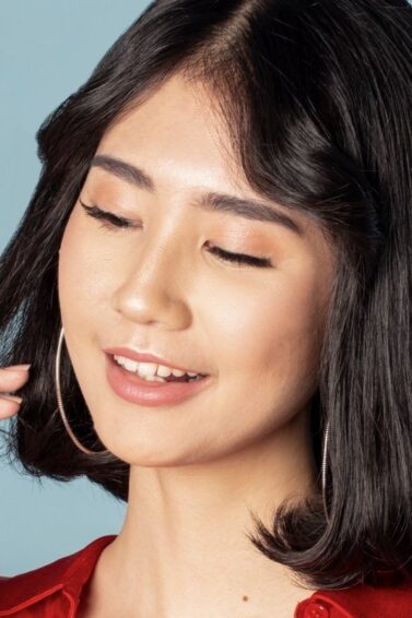 Asian woman with Korean short hair touching the tips of her hair