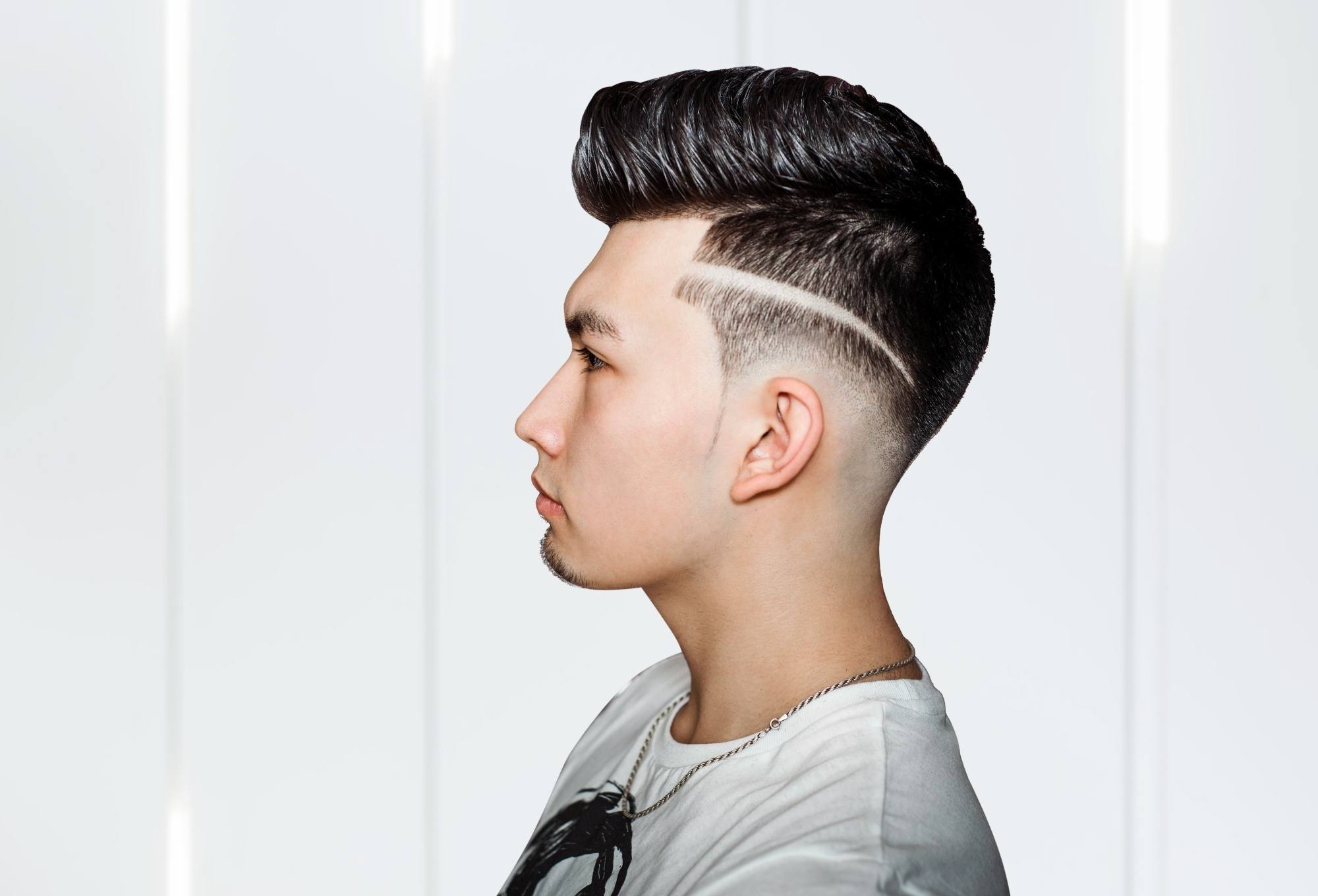 Side view of a man with an undercut haircut with design