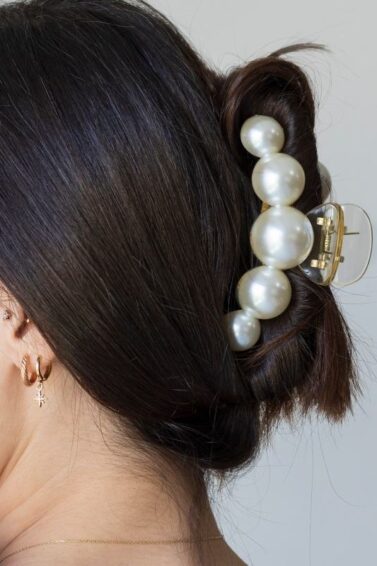 Woman with hair in an updo secured by a hair claw.