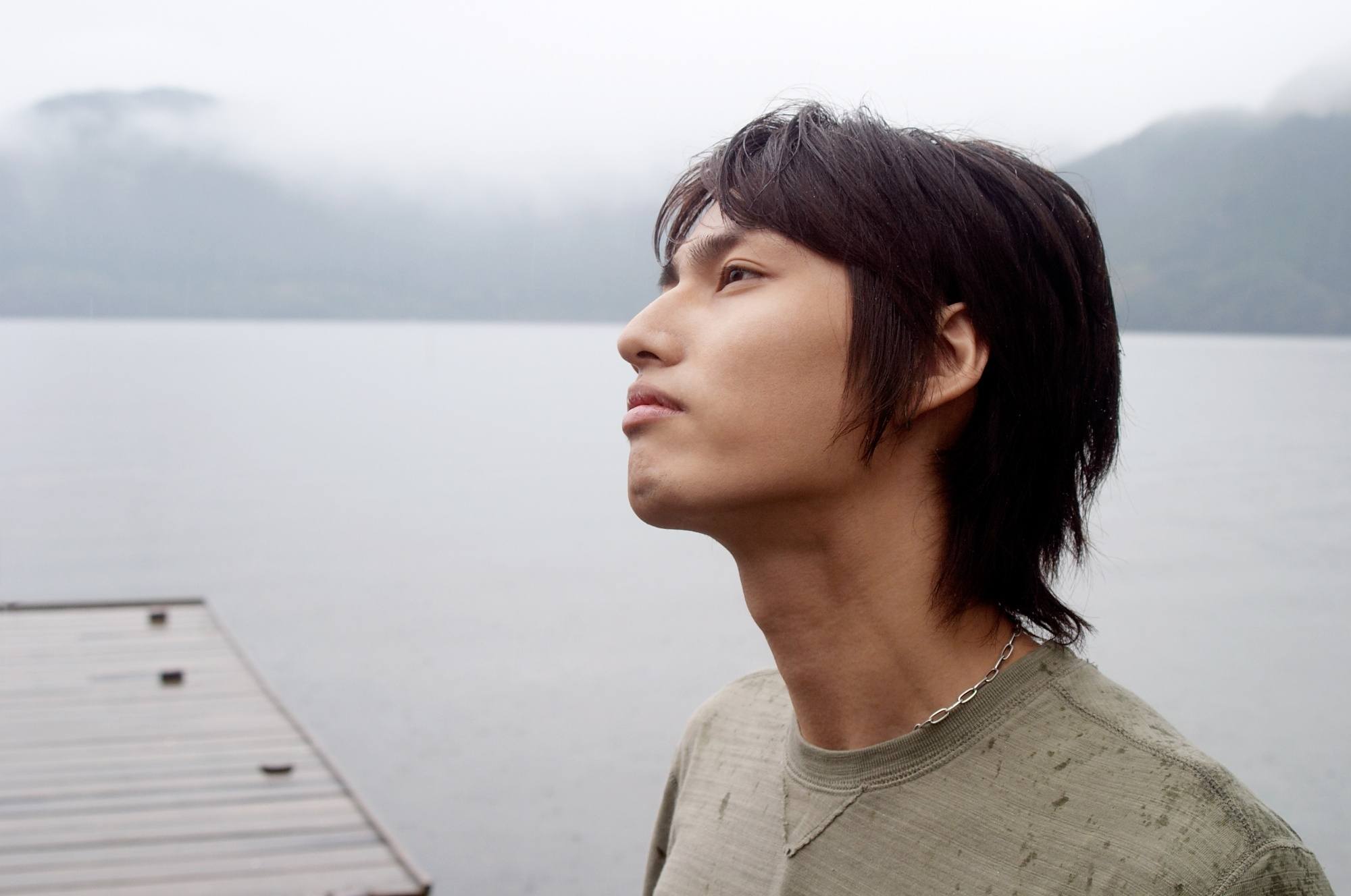 Side view of an Asian man with a wolf haircut.