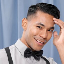 Asian man with a mid-fade haircut wearing a bow tie.