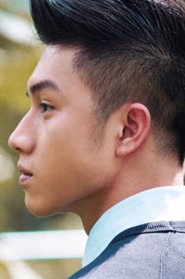 Side view of an Asian man with a faux hawk on V-cut hair.