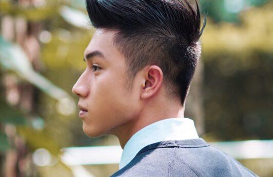 Side view of an Asian man with a faux hawk on V-cut hair.